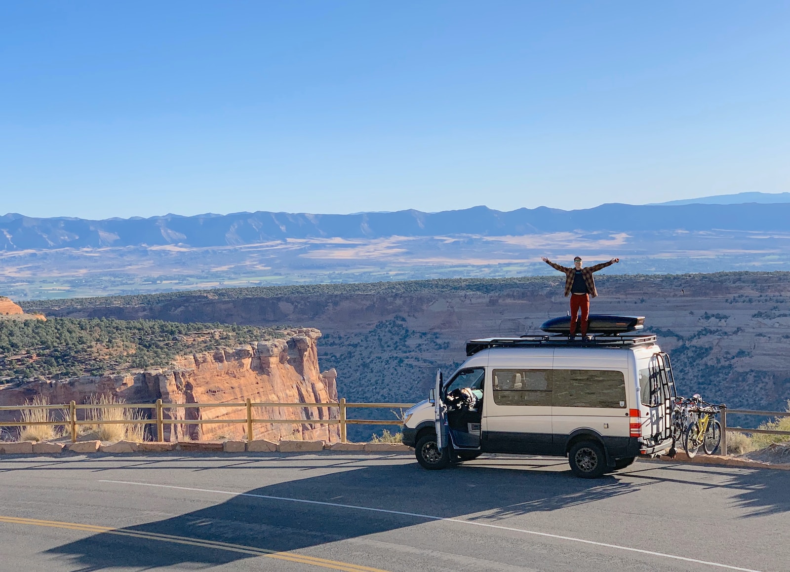 man standing on vehicle roof